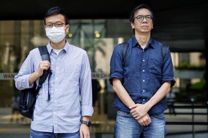 Chung Pui-kuen, former editor-in-chief of the now-shuttered Stand News, and Patrick Lam, former acting editor, leave court on June 27, 2023 after a hearing on charges of conspiring to publish seditious publications in Hong Kong.