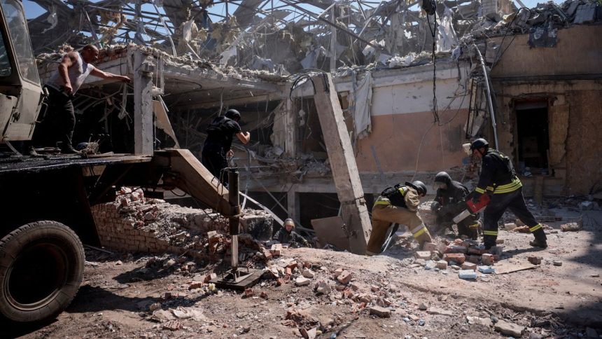 Ukrainian emergency personnel work among the rubble of a destroyed hotel in Kramatorsk on Sunday.