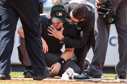 A medical staff member from the New York Yankees checks umpire Nick Mahrley after a broken bat hit him in the fifth inning of a game at Yankee Stadium on Sunday.