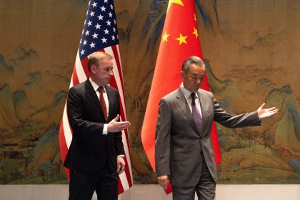 White House national security adviser Jake Sullivan and Chinese Foreign Minister Wang Yi walk together before talks at Yanqi Lake in Beijing on August 27.