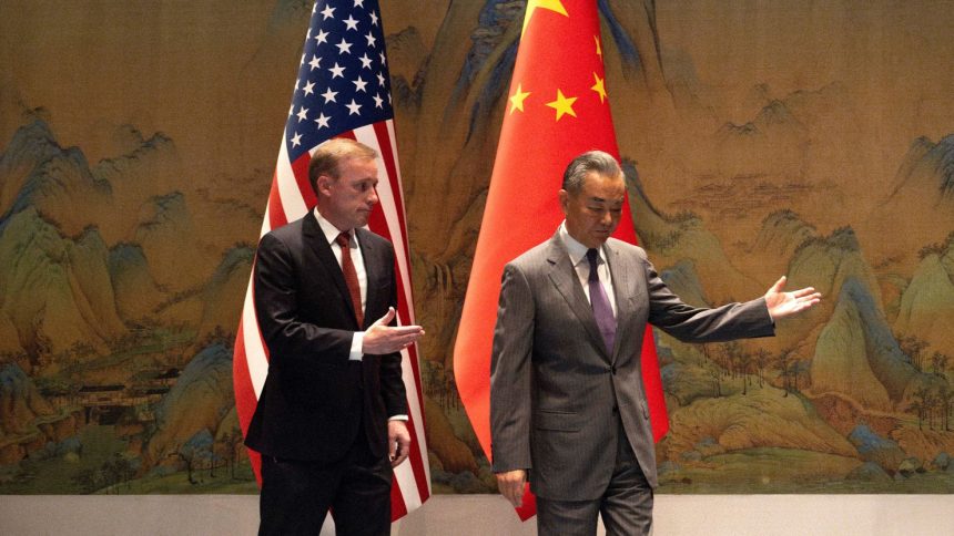 White House national security adviser Jake Sullivan and Chinese Foreign Minister Wang Yi walk together before talks at Yanqi Lake in Beijing on August 27.