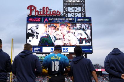 Players and fans stand for a moment of silence for NHL player Johnny Gaudreau who passed away the night before the game between the Philadelphia Phillies and the Atlanta Braves at Citizens Bank Park in Philadelphia, Pennsylvania, on August 30, 2024.