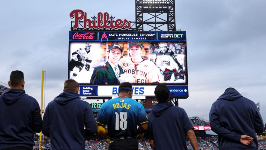 Players and fans stand for a moment of silence for NHL player Johnny Gaudreau who passed away the night before the game between the Philadelphia Phillies and the Atlanta Braves at Citizens Bank Park in Philadelphia, Pennsylvania, on August 30, 2024.