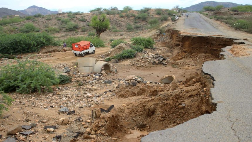 A truck bypasses a damaged road after intense flooding caused damage to infrastructure in southwest Yemen.