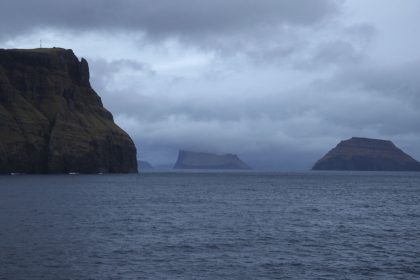 ILLUSTRATION - 08 March 2021, Faroe Islands, Tvoroyri: Cliffs of the Faroese island of Suduroy and several offshore islands can be seen from a ship that has left the port of Tvoroyri. Photo by: Steffen Trumpf/picture-alliance/dpa/AP Images