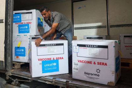 A worker unloads a shipment of polio vaccines provided with support from UNICEF to the Gaza Strip through the Karm Abu Salem crossing at a depot belonging to Gaza's health ministry on August 25.