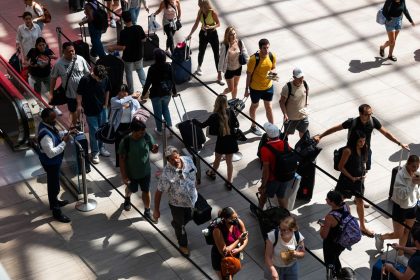 People line up in Moynihan Train Hall in New York City before the start of the 2023 Labor Day holiday weekend. This year's holiday weekend will be even busier, AAA says.