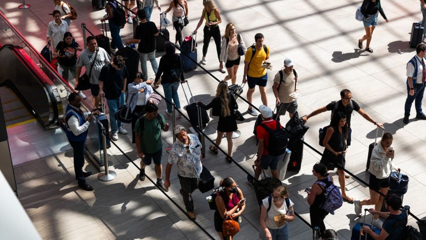 People line up in Moynihan Train Hall in New York City before the start of the 2023 Labor Day holiday weekend. This year's holiday weekend will be even busier, AAA says.