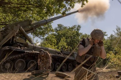 Ukrainian servicemen fire artillery toward Russian positions in an undisclosed area in the Pokrovsk district of Ukraine.