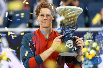 Jannik Sinner of Italy poses with the trophy after defeating Frances Tiafoe to win the Cincinnati Open final.