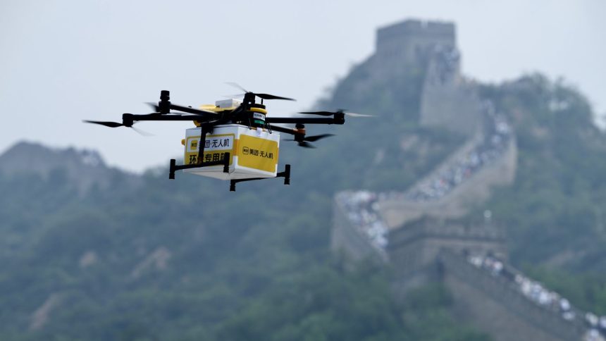 A drone carries a package from Chinese food delivery giant Meituan to the Badaling section of the Great Wall in Beijing, China, on August 16, 2024.