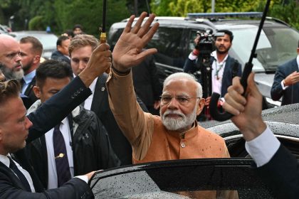 Indian Prime Minister Narendra Modi waves as he leaves a memorial in Warsaw, Poland on August 21.