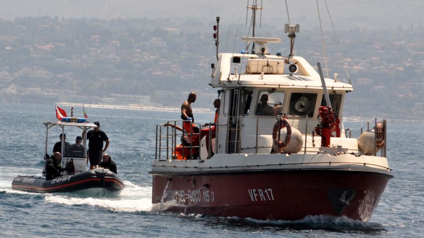 Divers enter Porticello harbor near Palermo, with the body of Hannah Lynch at the back of the boat on Friday.