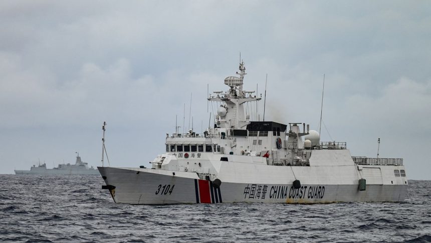 A China Coast Guard ship and a vessel identified by the Philippine Coast Guard as a Chinese navy ship are seen in disputed waters of the South China Sea on August 26, 2024.