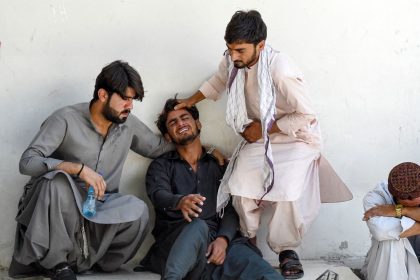 TOPSHOT - A man (2L) mourns the death of his father, who died in a separatist militants shooting, at a hospital in Quetta on August 26, 2024. Separatist militants killed at least 39 people in "coordinated" attacks in southwestern Pakistan on August 26, that largely targeted ethnic Punjabis, government officials said. (Photo by Banaras KHAN / AFP) (Photo by BANARAS KHAN/AFP via Getty Images)