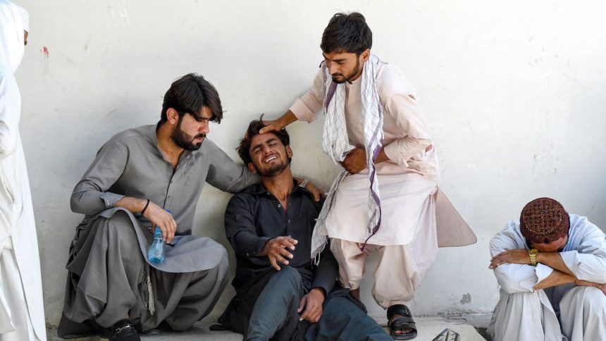 TOPSHOT - A man (2L) mourns the death of his father, who died in a separatist militants shooting, at a hospital in Quetta on August 26, 2024. Separatist militants killed at least 39 people in "coordinated" attacks in southwestern Pakistan on August 26, that largely targeted ethnic Punjabis, government officials said. (Photo by Banaras KHAN / AFP) (Photo by BANARAS KHAN/AFP via Getty Images)