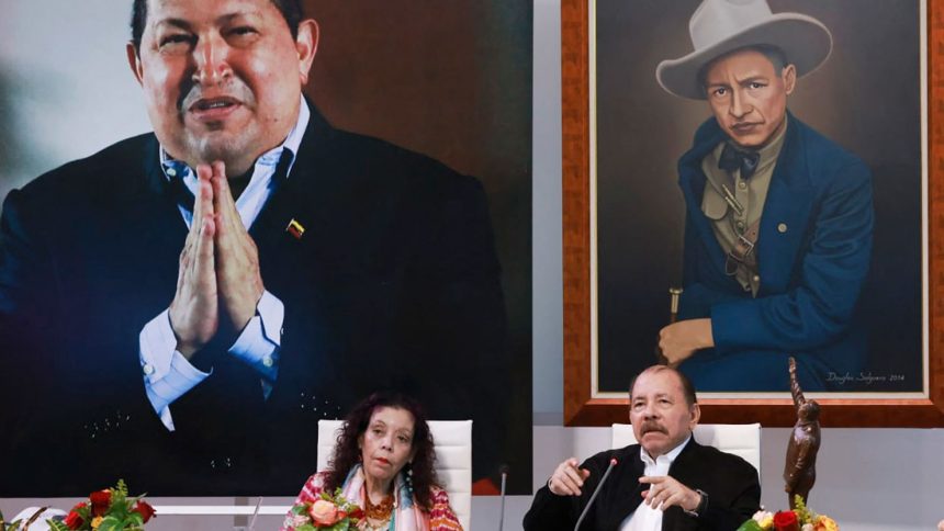 Nicaraguan President Daniel Ortega, above next to his wife and Vice President Rosario Murillo, and in front of a giant photo of the late Venezuelan former President Hugo Chavez, takes part in a virtual summit in Managua, Nicaragua, on August 26, 2024.