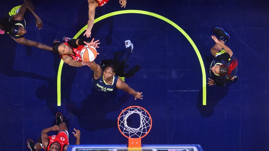 A'ja Wilson (left) goes for a rebound against the Dallas Wings.