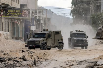 Israeli army armoured vehicles move along a road during a military operation in Tulkarm in the north of the occupied West Bank on August 29, 2024. Israel on August 28 launched a large-scale operation in the occupied West Bank where the military said it killed Palestinian fighters, as the nearly 11-month-old Gaza war showed no signs of abating. (Photo by Jaafar ASHTIYEH / AFP) (Photo by JAAFAR ASHTIYEH/AFP via Getty Images)