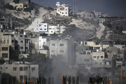 Smoke rises among buildings during an Israeli army raid in Jenin in the occupied West Bank on August 30, 2024. An Israeli air strike hit the occupied West Bank as its large-scale military operation entered a third day, with the military killing at least 16 Palestinians. (Photo by RONALDO SCHEMIDT / AFP) (Photo by RONALDO SCHEMIDT/AFP via Getty Images)