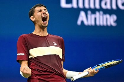 Alexei Popyrin celebrates winning a break point against Novak Djokovic.