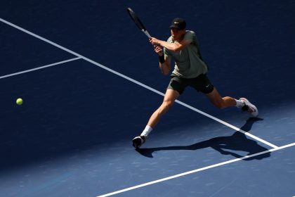 Jannik Sinner returns against Mackenzie McDonald in the first round of the US Open.