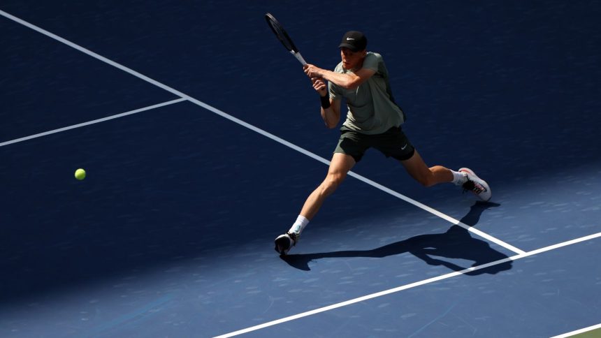 Jannik Sinner returns against Mackenzie McDonald in the first round of the US Open.