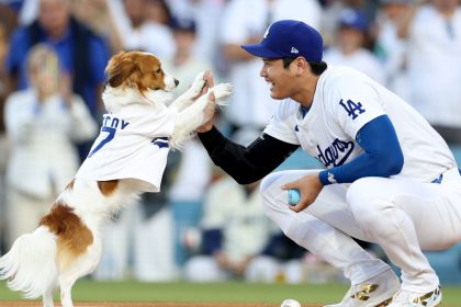 LOS ANGELES, CALIFORNIA - AUGUST 28: Shohei Ohtani #17 of the Los Angeles Dodgers and his dog Decoy delivers a ceremonial first before the game against the Baltimore Orioles on Shohei Ohtani #17 bobblehead giveaway night at Dodger Stadium on August 28, 2024 in Los Angeles, California. (Photo by Harry How/Getty Images)