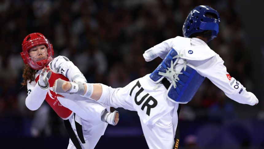 PARIS, FRANCE - AUGUST 29: Zakia Khudadadi of Refugee Paralympic Team and Nurcihan Ekinci of Team Turkey compete in the Women's K44-47kg Repechage, Contest 128 on day one of the Paris 2024 Summer Paralympic Games at Grand Palais on August 29, 2024 in Paris, France. (Photo by Steph Chambers/Getty Images)