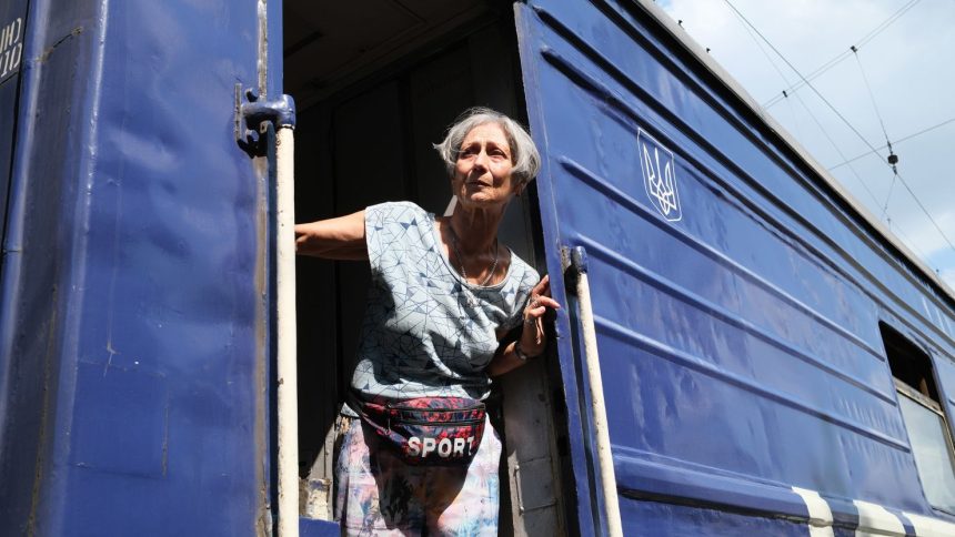 A woman from the Pokrovsk area boards an evacuation train amid continuing Russian advances toward the city.