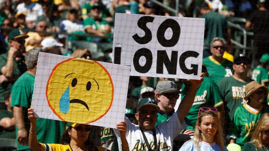 Oakland A's fans holding up signs bidding farewell to the team in their final game at the Oakland Coliseum