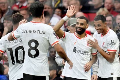 Liverpool players, including Mohamed Salah (second right), celebrate after scoring against Manchester United.