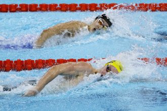 Australia's Sam Short and Korea's Kim Woo-min (top) compete in the 400-meter freestyle heats in Paris.