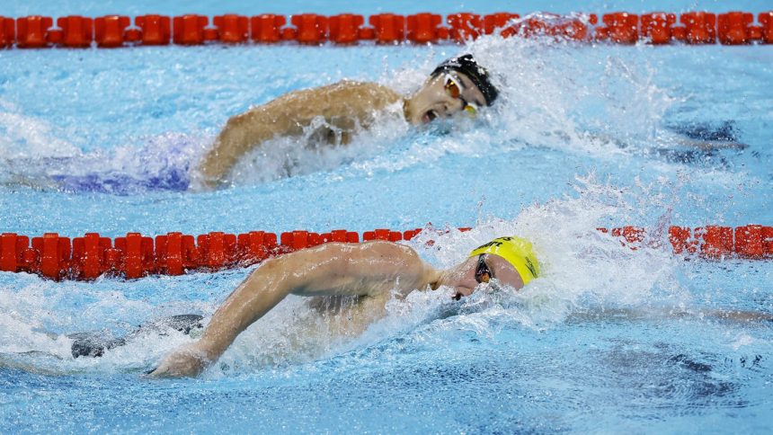 Australia's Sam Short and Korea's Kim Woo-min (top) compete in the 400-meter freestyle heats in Paris.