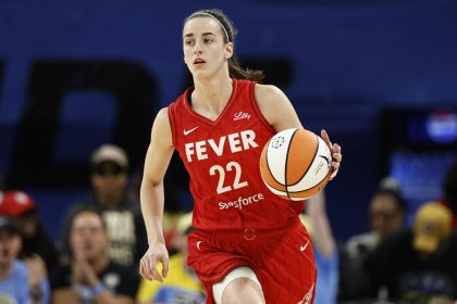 Caitlin Clark brings the ball up the court during a WNBA game against the Chicago Sky.