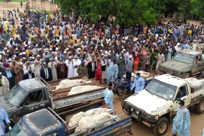 Trucks carry the wrapped bodies of people killed by suspected Boko Haram militants, during their funeral in Yobe, Nigeria, on September 3, 2024.