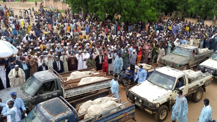 Trucks carry the wrapped bodies of people killed by suspected Boko Haram militants, during their funeral in Yobe, Nigeria, on September 3, 2024.