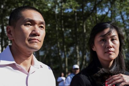 Linda Sun, a former aide to New York State Gov. Kathy Hochul, exits Brooklyn Federal court accompanied by her husband, Chris Hu.