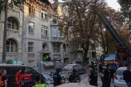 Police officers and emergency workers stand in front of a residential building damaged during a Russian drone and missile strike, amid Russia's attack on Ukraine, in Lviv, Ukraine September 4, 2024. REUTERS/Roman Baluk