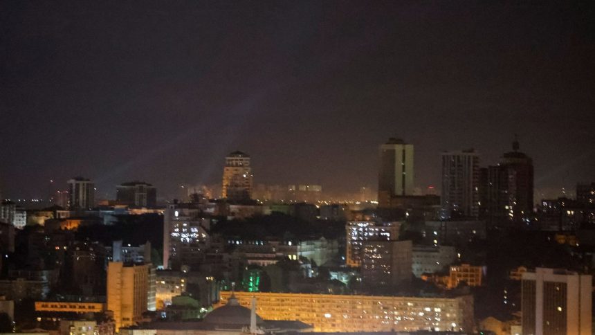 Ukrainian service personnel use searchlights as they search for drones in the sky over the city center during a Russian drone strike in Kyiv, Ukraine, September 7, 2024.