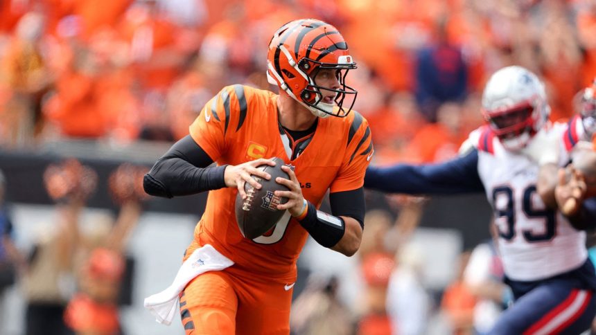 Joe Burrow runs the ball during the first quarter of the Cincinnati Bengals' game against the New England Patriots.