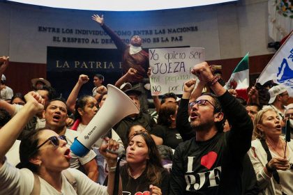 Demonstrators raise their fists after entering the Senate building on Tuesday, September 10, 2024.