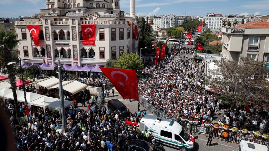 People carry the Turkish flag-draped coffin of Aysenur Ezgi Eygi, a Turkish-American activist killed in the Israeli-occupied West Bank, during her funeral ceremony in Didim.