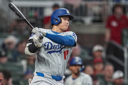 Los Angeles Dodgers designated hitter Shohei Ohtani doubles to drive in a run against the Atlanta Braves during the fifth inning at Truist Park.