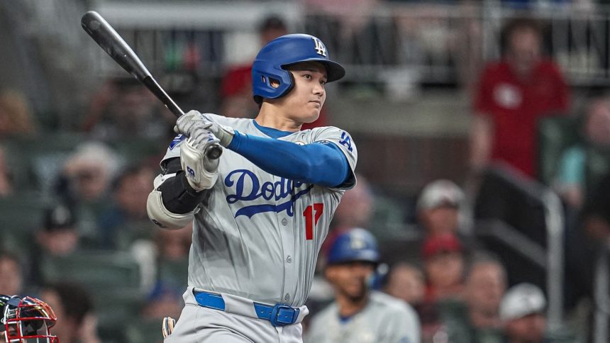 Los Angeles Dodgers designated hitter Shohei Ohtani doubles to drive in a run against the Atlanta Braves during the fifth inning at Truist Park.