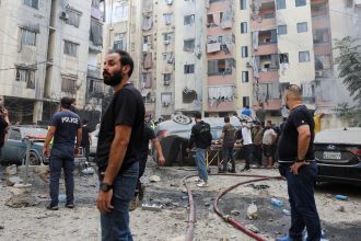 People inspect the site of an Israeli strike in the southern suburbs of Beirut, Lebanon, September 20, 2024. REUTERS/Mohamed Azakir