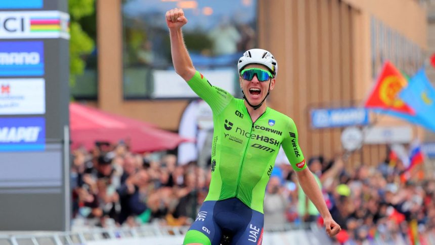 Tadej Pogačar celebrates winning the world championship men's road race.