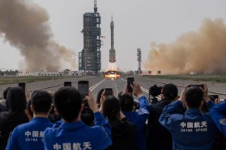 JIUQUAN, CHINA - MAY 30: Members from China's Manned Space Agency and visitors watch as the Shenzhou-16 spacecraft onboard the Long March-2F rocket launches at the Jiuquan Satellite Launch Center on May 30, 2023 in Jiuquan, China. The three astronaut crew of the Shenzhou-16 spacecraft will be carried to China's new Tiangong Space Station and will replace a similar crew that have been at the station for the last six months.(Photo by Kevin Frayer/Getty Images)