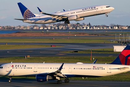 A United Airlines jet takes off while a Delta Air Lines plane taxis at Logan International Airport in Boston.