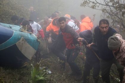 In this photo provided by Moj News Agency, a rescue team works at the crash site of the helicopter carrying Iranian President Ebrahim Raisi in Varzaghan, northwestern Iran, on May 20, 2024.